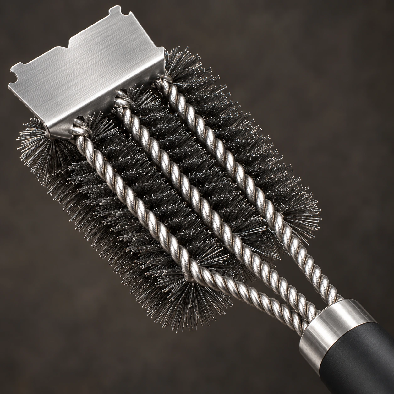 Détail des trois cordes inox torsadées et des rangs de poils d'acier serrés de la brosse à gril