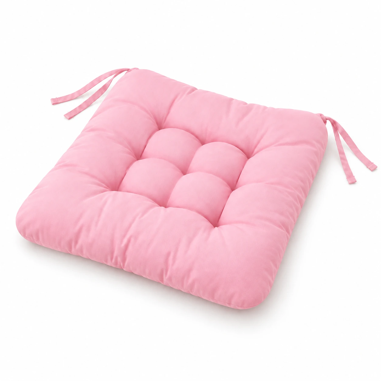 Coussin d'assise rose capitonné vu de trois quarts sur fond blanc, rubans de fixation aux angles