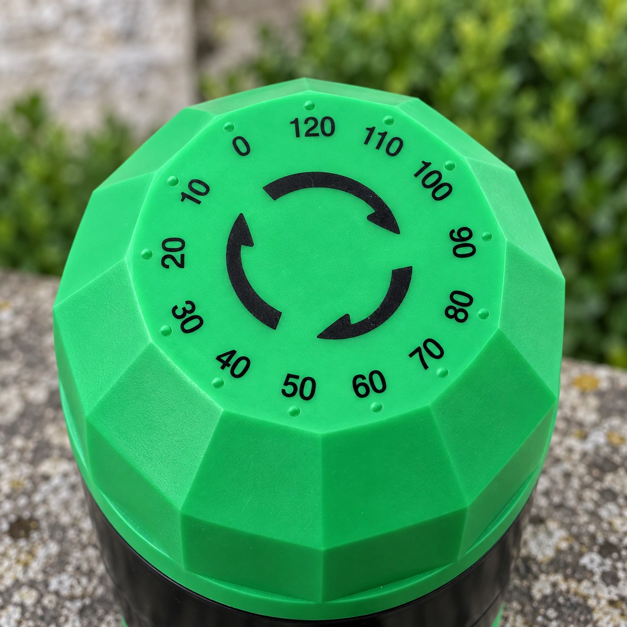 Gros plan du cadran vert facetté, gradué de 0 à 120 minutes, du minuteur d'arrosage